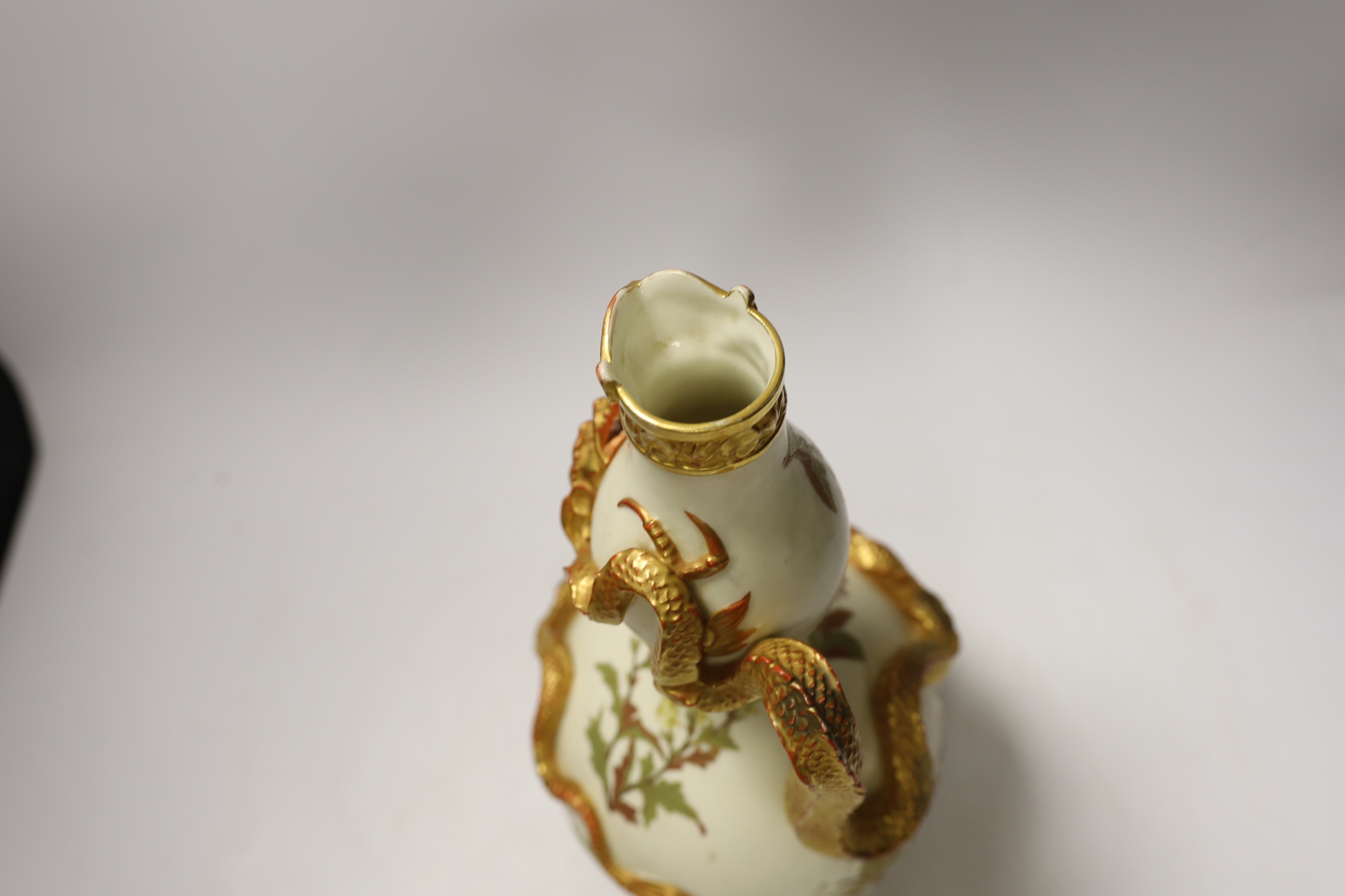 A Royal Worcester ewer with dragon handle, numbered 1035, 29cm high